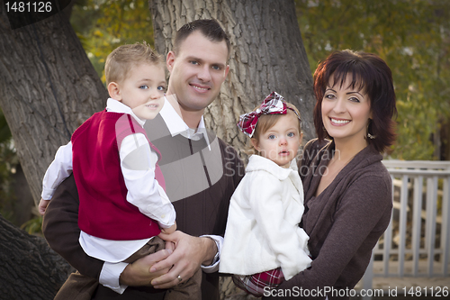 Image of Young Attractive Parents and Children Portrait in Park