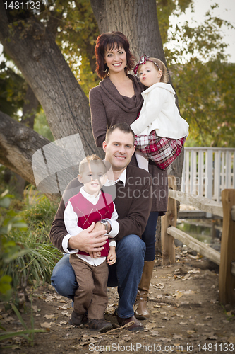 Image of Young Attractive Parents and Children Portrait in Park