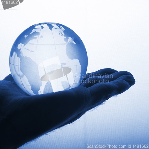 Image of hand holding globe