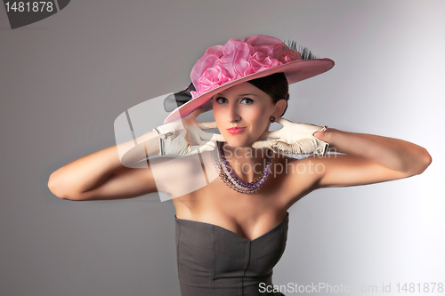 Image of Young stylich woman with purple retro hat