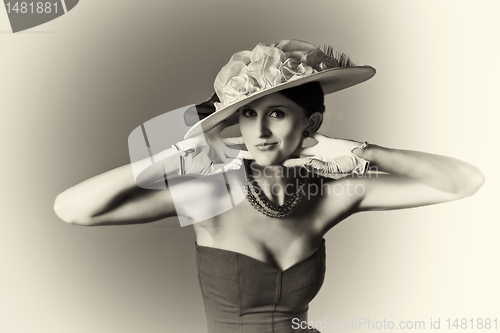 Image of Young srtylish woman with retro hat