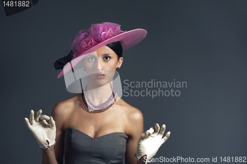 Image of Young stylich woman with purple retro hat