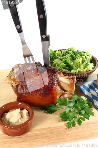 Image of knuckle of pork with cutlery