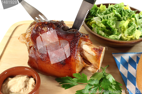 Image of fresh knuckle of pork with cutlery