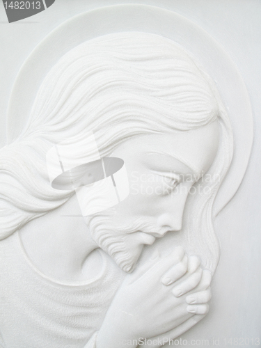 Image of jesus christ on white marble tombstone