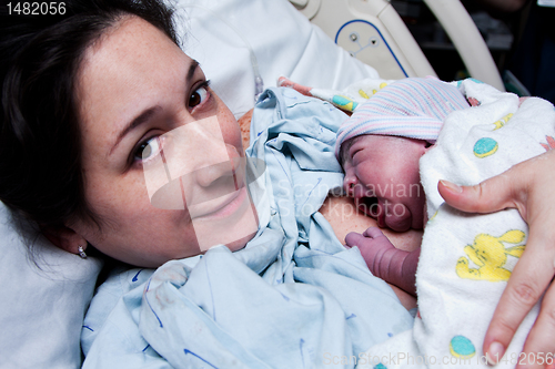 Image of Happy mother holding newborn baby after birth