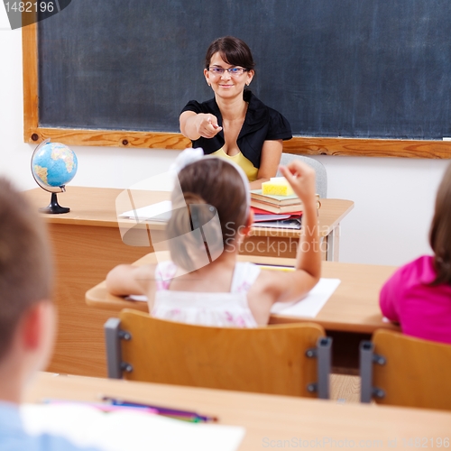 Image of Teacher pointing at schoolgirl