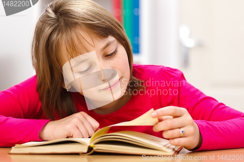 Image of Schoolgirl reading in classroom