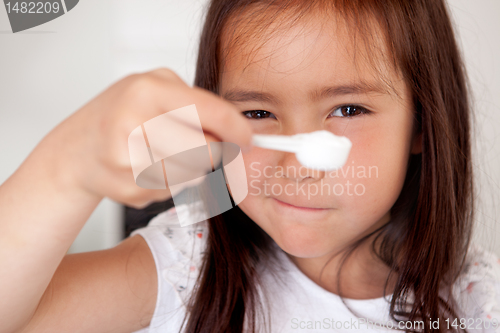 Image of Young girl Measuring Ingredient