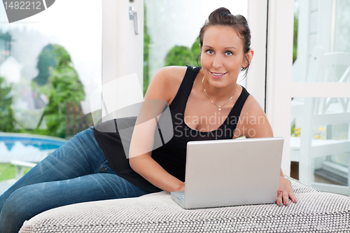 Image of Portrait of woman using laptop