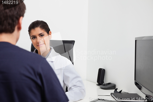 Image of Female dentist at her desk