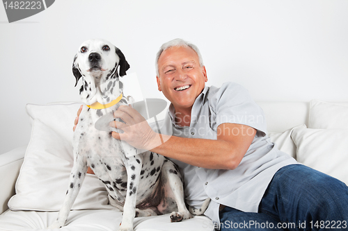 Image of Senior Man Sitting With His Dog