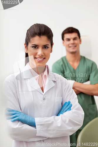 Image of Happy female dentist smiling with arms crossed