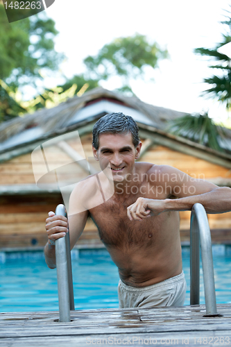 Image of Smiling Middle Aged Man Standing in Pool