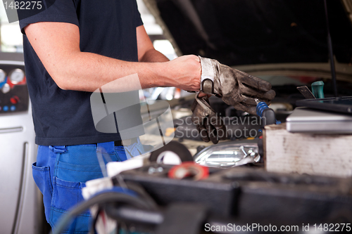 Image of Mechanic Putting on Work Gloves