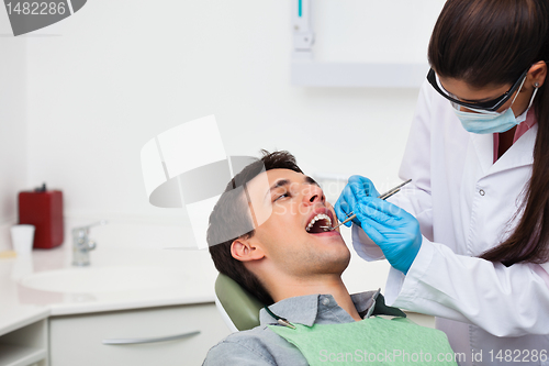 Image of Dentist examining patient