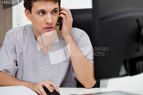 Image of Doctor talking on cell phone