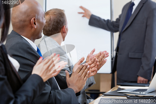 Image of Business people applauding during presentation