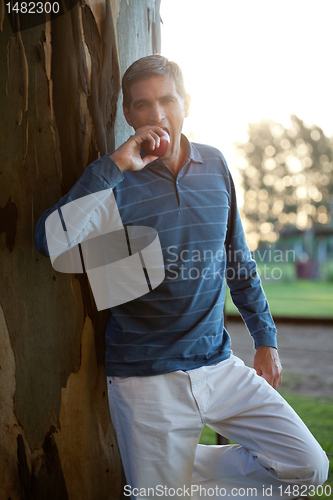Image of Casual Middle Aged Man Eating Apple