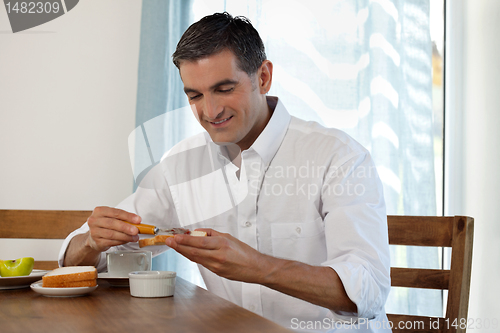 Image of Smiling Man Having Breakfast