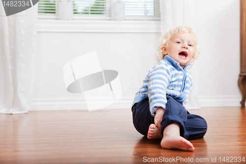 Image of Boy sitting on the floor