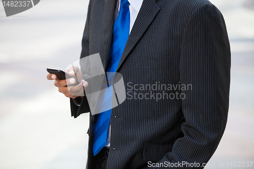 Image of Businessman using cell phone