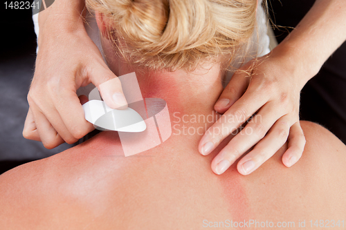 Image of Woman Receiving GuaSha Treatment on Neck