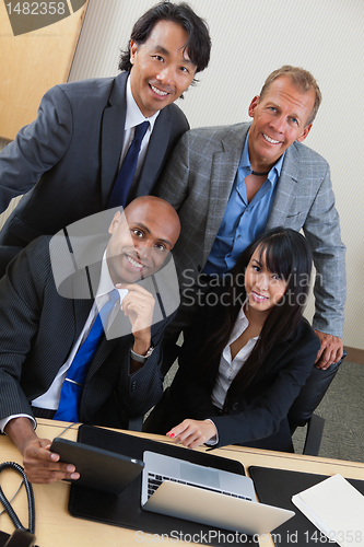 Image of Business people working on laptop together