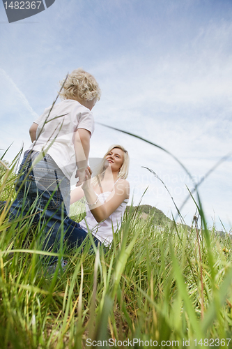 Image of Mother and little boy in grass