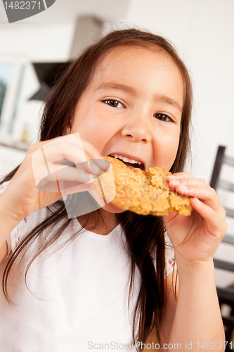 Image of Young Girl Eating Cookie