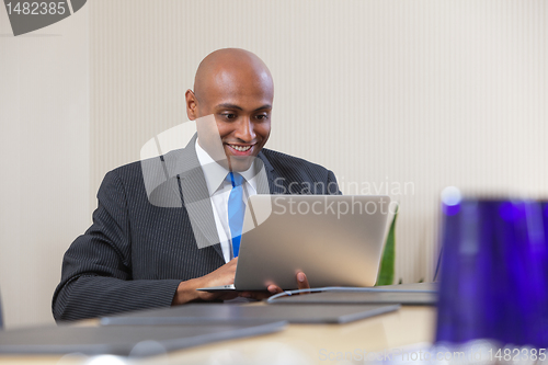 Image of Businessman working on laptop