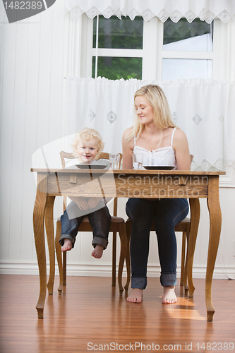 Image of Woman and baby at dining table