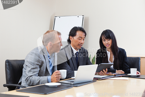 Image of Business people using tablet in meeting