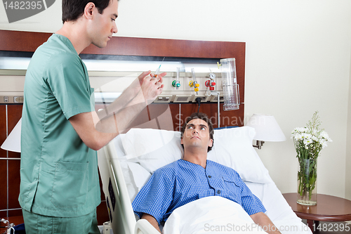 Image of Doctor about to inject to patient