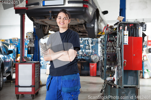 Image of Smiling young female mechanic in garage