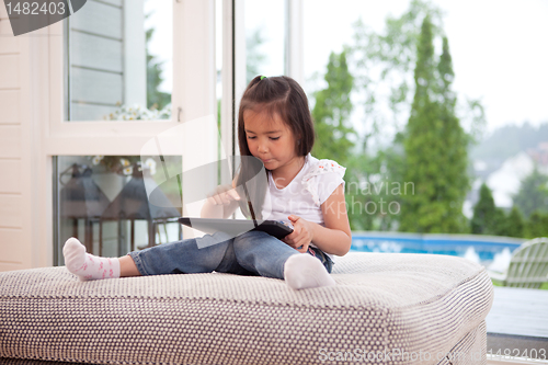 Image of Child Playing with Digital Tablet