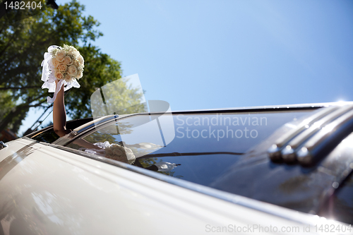 Image of Bride Waving Hand Holding Bouquet