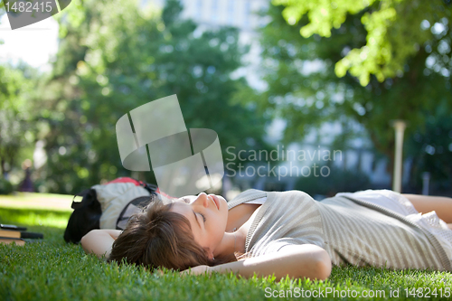 Image of Girl asleep on the grass