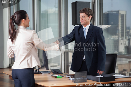 Image of Business People Shaking Hands Over A Deal