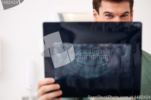 Image of Young Male Dentist with X-ray