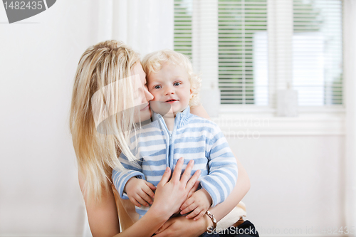 Image of Mother hugging child