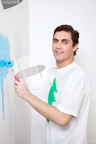 Image of Man painting house