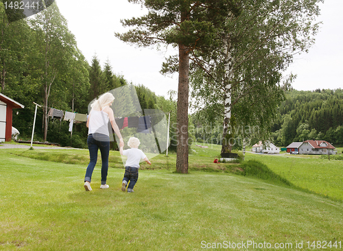 Image of Woman and child walking in garden