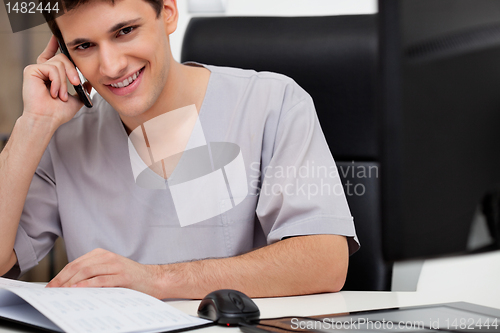 Image of Doctor talking on phone