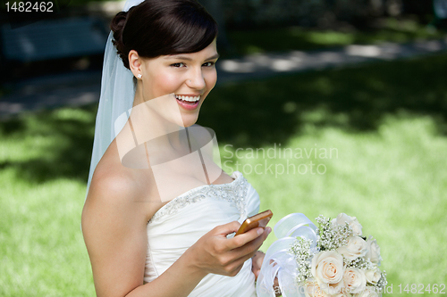 Image of Bride Using Cell Phone