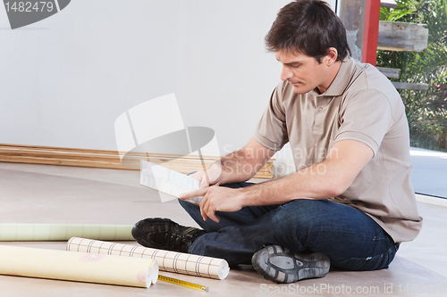 Image of Young man looking at color sample