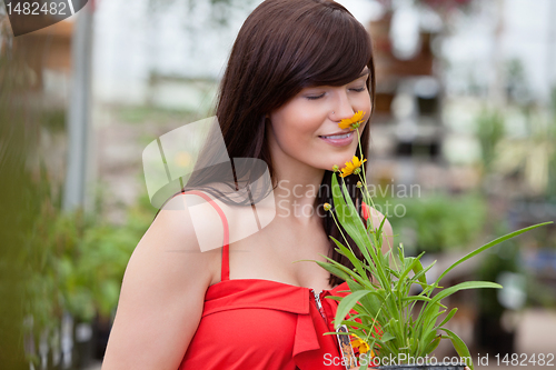 Image of Woman smelling flower