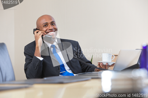 Image of Businessman talking on telephone