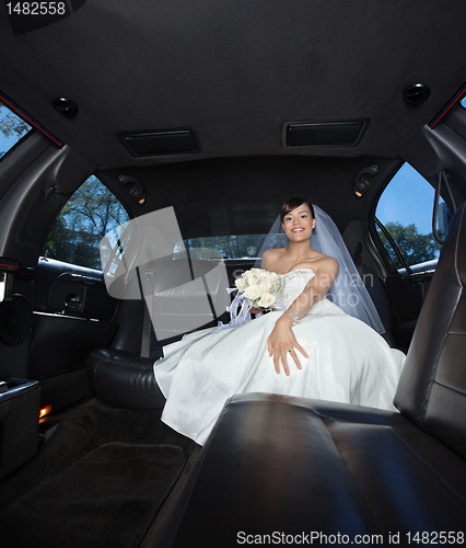 Image of Bride Sitting in Limousine