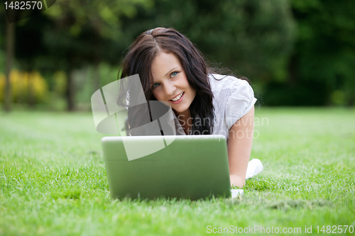 Image of Casual Female Using Laptop in Park